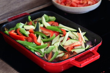 A hearty homemade Czech-style lecsó (lečo), featuring colorful bell peppers, fried egg, slices of sausage, and fresh bread, served straight from the pot.