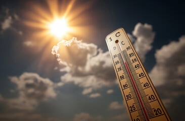 A wooden thermometer with the sun shining in the background, a red ball on top of it showing high temperature.