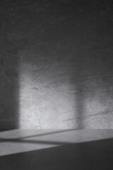 Concrete background that can be used in various designs with shadows of sunlight through the window.