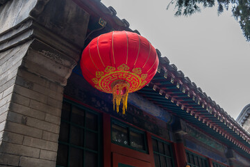 Red chinese lantern hanging from the roof. Oriental temple decoration