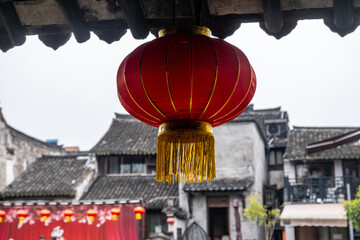 Red chinese lantern hanging from the roof. Oriental temple decoration