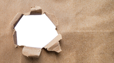 Torn brown kraft paper and holes on the sides