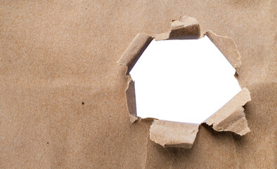 Torn brown kraft paper and holes on the sides