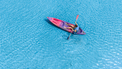 Aerial view of a kayak in the blue sea .man kayaking he does water sports activities.	