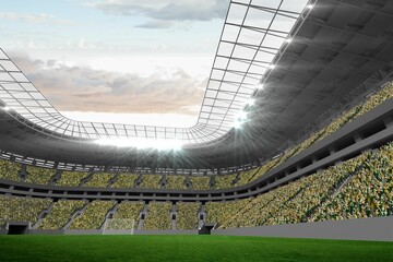 Modern sports stadium is showcasing green grass pitch, floodlit transparent roof and cheering crowd