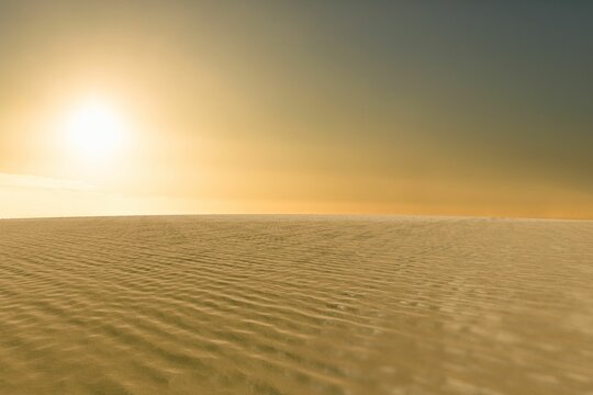 Fototapeta Flat design desert landscape is showing rippled dunes casting shadows under warm glowing sun
