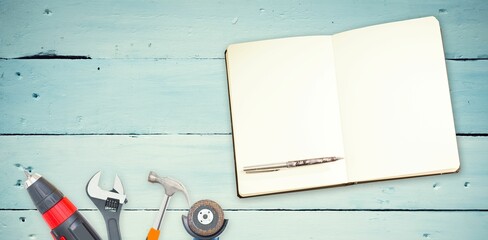 Tools and notepad on wooden background