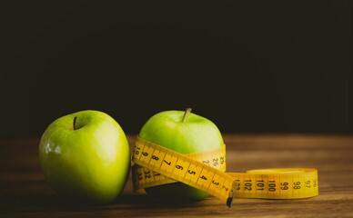 Green apples and measuring tape