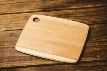 Chopping board on brown wooden flooring