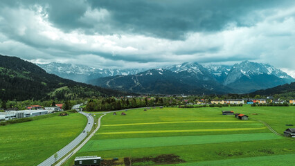 Scenic view of snowy mountains behind farmhouses