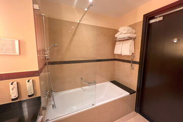 Tiled bathroom with classic bathtub design