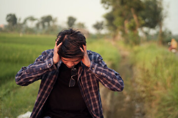Man Experiencing Stress and Anxiety in a Rural Setting