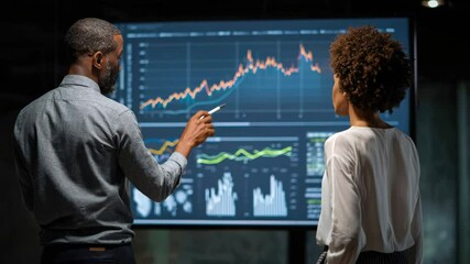 African American man presenting data graph to businesswoman - Powered by Adobe
