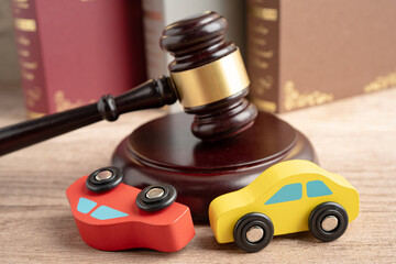 Car accident lawsuit and insurance, Judge hammer with car model.