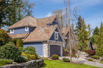 Two story stucco luxury house with nice spring blossom landscape in Vancouver, Canada, North...