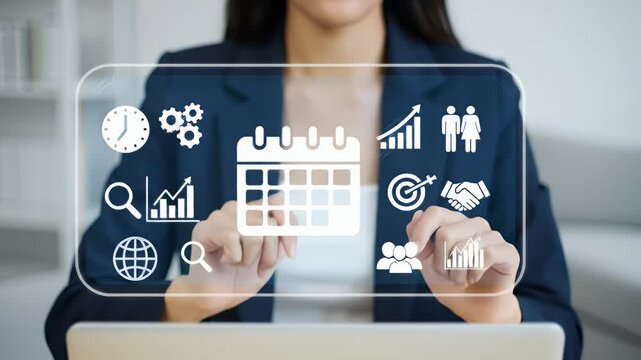 Businesswoman Interacting with Transparent Digital Interface with Planning Icons in Blue Blazer in Bright White Office Setting