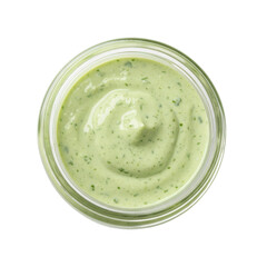 Creamy green sauce in a clear jar, showcasing a smooth texture against a white background