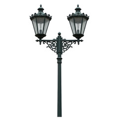 Elegant street lamp with ornate design illuminating a quiet urban setting at dusk