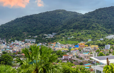 view of Patong and Patong Beach from the mountains colourful skies at Sunset. Patong is a vibrant...
