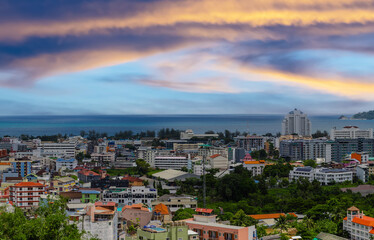 view of Patong and Patong Beach from the mountains colourful skies at Sunset. Patong is a vibrant...