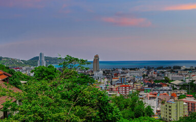 view of Patong and Patong Beach from the mountains colourful skies at Sunset. Patong is a vibrant...