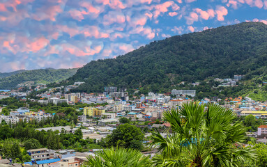 Obraz premium view of Patong and Patong Beach from the mountains colourful skies at Sunset. Patong is a vibrant city full of tourists from all around the world. 
