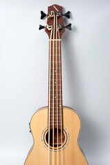 Four-string bass ukulele with wooden body and built-in tuner and pickup.