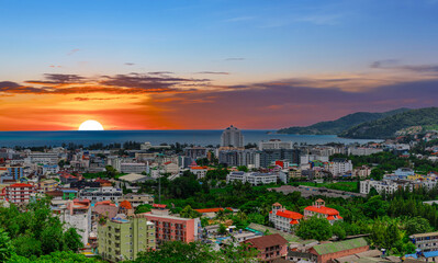view of Patong and Patong Beach from the mountains colourful skies at Sunset. Patong is a vibrant city full of tourists from all around the world. 