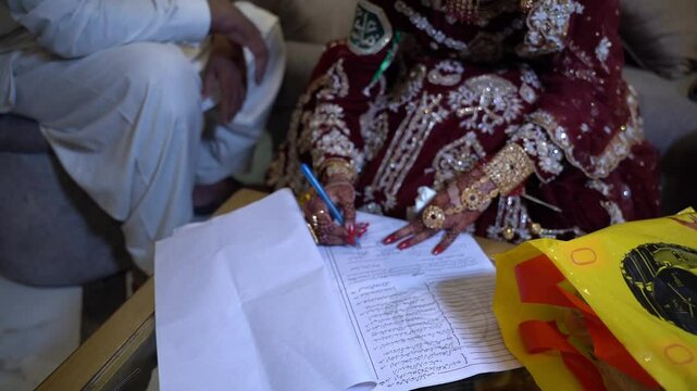 . Pakistani Muslim bridal sign wedding contract, woman in traditional clothing store