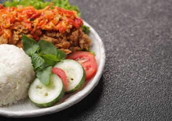 Ayam geprek is a typical Indonesian fried chicken dish with flour that is mashed or mashed with plow chili sauce