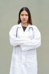 Young Asian woman doctor wearing white lab coat and stethoscope with arms crossed