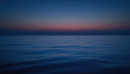 Obraz premium Tranquil Ocean Scene at Dusk with Soft Waves and Colorful Sky Gradation