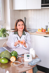 A doctor in a white coat holding a handful of transparent yellow oval capsules in his palms. food...