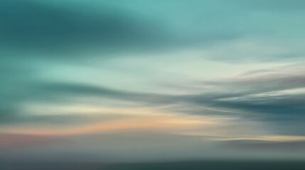 Obraz premium Gentle turquoise sky embraces soft clouds, blending seamlessly in a serene, blurred dawn atmosphere