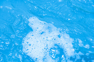Blue water with ripples on the surface. Defocus blurred transparent blue colored clear calm water...