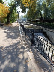 Scenic autumn view of a park with a waterway and trees.