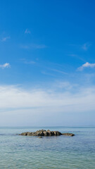 A stunning tropical island landscape with a pristine beach and turquoise water under a blue sky