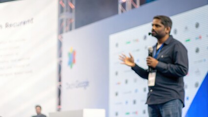 Fototapeta premium Defocused tech event with Indian speaker discussing innovation trends 