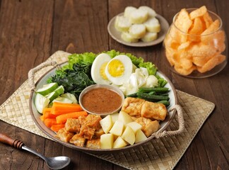 Gado-gado is a food consisting of vegetables, potatoes, tempeh, tofu, boiled eggs, etc. seasoned with peanut sauce and so on.