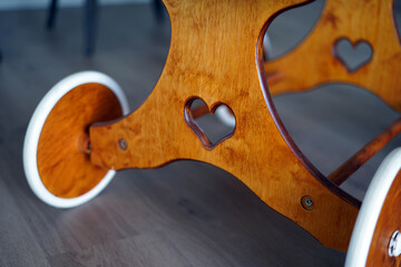 Heart symbol carved in wood. This is the chassis of a historical baby basket.
