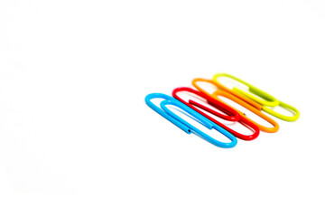 Colorful paper clips arranged on a white background, perfect for office or school related designs and presentations