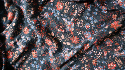 Photo background made of printed fabric. Chaotic folds in different places. Ornament made of...