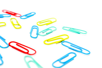 Vibrant Paper Clips Scattered on White Background, A Colorful Office Supply Collection
