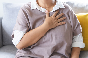 Chest pain, attack chest, emergency heartbeat asian senior woman holding hand on chest, suffering...