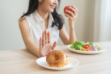 Diet, dieting, happy asian young woman, girl hand push out, deny sweet donut, doughnut on plate,...