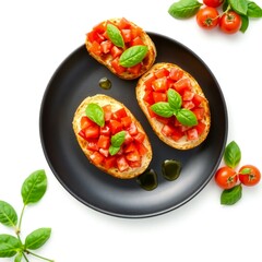 Delicious bruschetta with fresh tomatoes and basil on a black plate