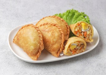 Pastel Goreng in Indonesia, pastel refers to a type of kue filled with meat, vegetables, and rice vermicelli deep fried in vegetable oil. It is consumed as a snack and commonly sold in Indonesian trad