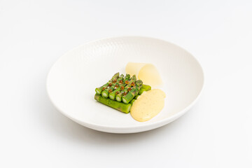 Steamed asparagus with hollandaise sauce and decorative potatoes