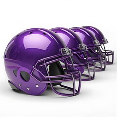 Fototapeta premium A row of shiny purple football helmets with face masks against a white studio background display