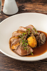 Sliced pan-seared duck breast with crispy skin and rich brown sauce